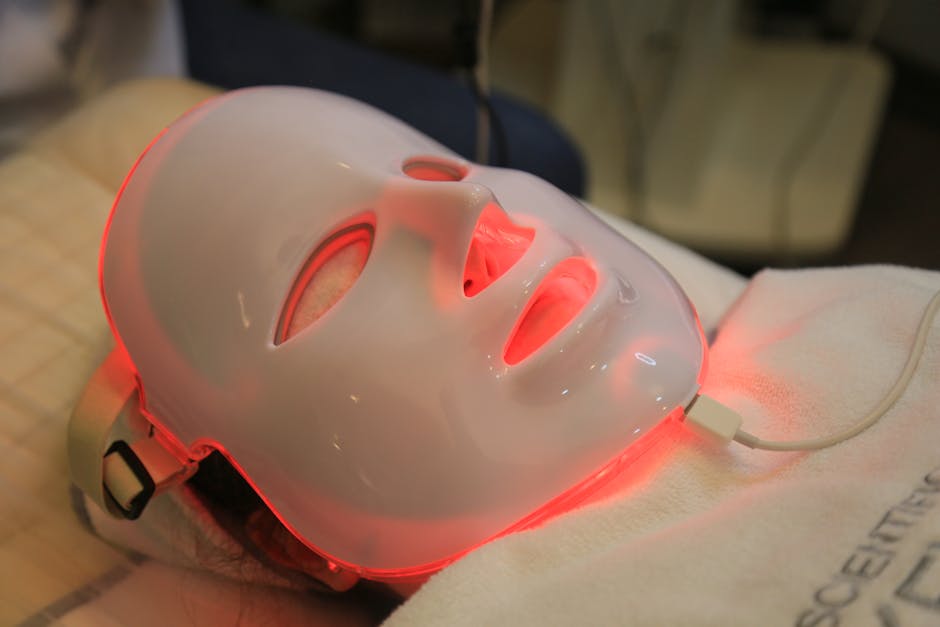 Client lying back in a red light LED face mask